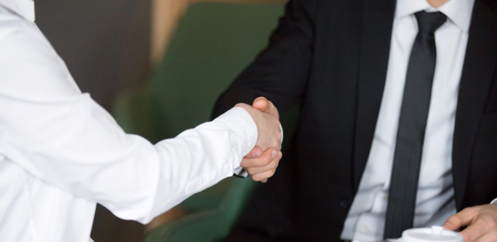 Businessman handshaking businesswoman showing respect, female and male hands shaking as concept of good business deal, gratitude for help or advice, successful partnership and teamwork, close up view